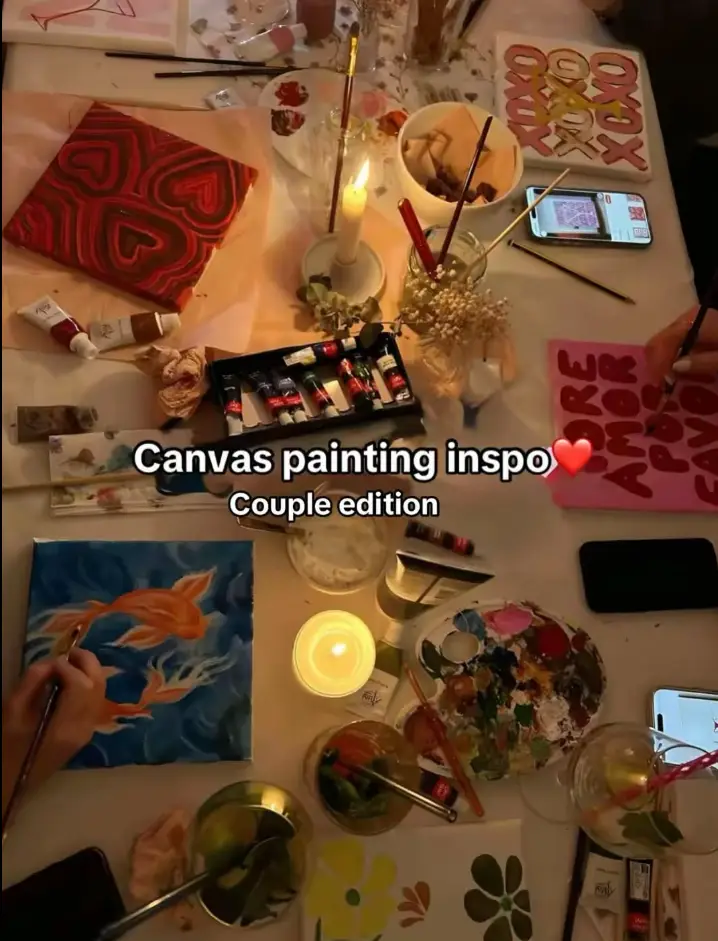 A candlelit couples painting table set up for a date night at Travel & Paint