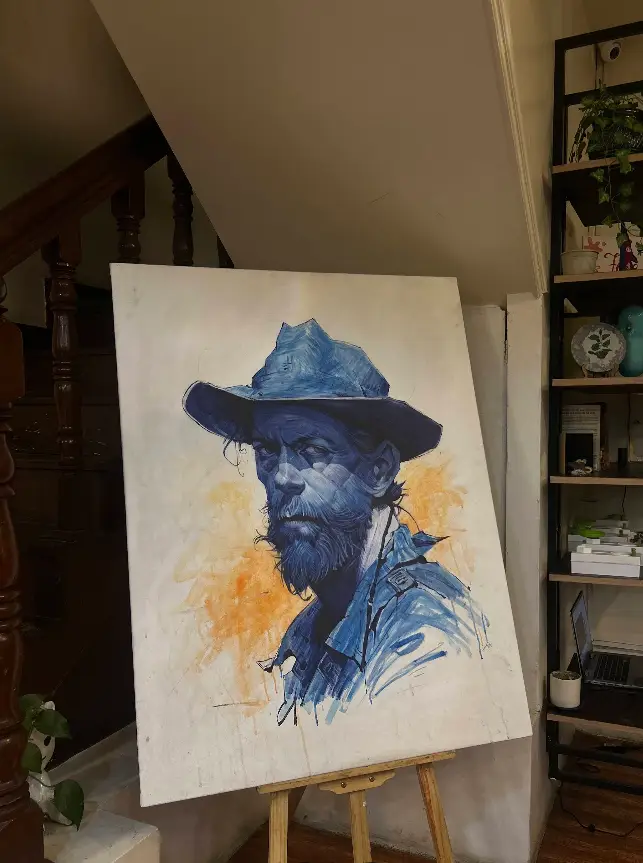 A finished blue-toned portrait painting on an easel