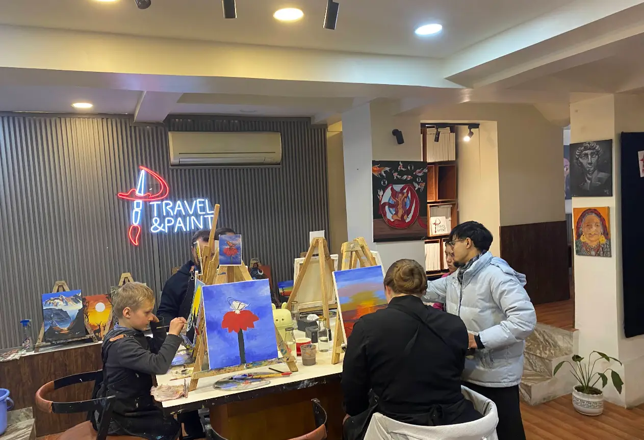 Painters mid-session at the Travel & Paint studio in Baluwatar, Kathmandu